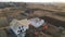 Aerial view of unfinished frame of private house with aerated lightweight concrete walls and wooden roof frame under