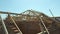 Aerial view of unfinished residential house with wooden roof frame structure under construction