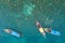 Aerial view of unidentified tourists snorkeling activity on tropical island near Lipe Island, Satun, Thailand.