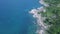 Aerial view of uninhabited tropical island with rocky sea shore