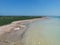 Aerial view of an unoccupied beach with a tranquil blue sky above