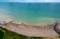 Aerial view of an unoccupied beach with a tranquil blue sky above