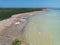 Aerial view of an unoccupied beach with a tranquil blue sky above