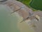 Aerial view of an unoccupied beach with a tranquil blue sky above