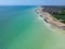 Aerial view of an unoccupied beach with a tranquil blue sky above