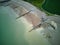 Aerial view of an unoccupied beach with a tranquil blue sky above