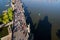 Aerial view of unrecognizable tourist walking on the Charles Bridge with small boat on Vltava river, Prague, Czech Republic