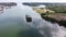 Aerial view of unserviceable barge boat anchored in harbor waiting maintenance.