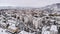 Aerial view of an urban cityscape of snow-covered traditional housing suburbs in the wintertime