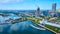 Aerial View of Urban Waterfront, Suspension Bridge, and Skyscraper Construction