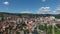 Aerial View of Uzice City, Serbia. Colorful Valley Town Under Summer Sun, Drone