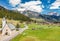 Aerial view of valley with Chalet, green slopes of the mountains of Italy, Trentino, Fontanazzo, huge clouds over a