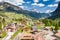 Aerial view of valley with Chalet, green slopes of the mountains of Italy, Trentino, Fontanazzo, huge clouds over a