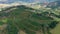 Aerial view of valley with farm field, forest and villa in tropical country