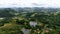 Aerial view of valley with lake, forest and villa in tropical country