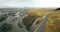 Aerial view of the valley with melting glacier on it and mountains. Beautiful landscape of Icelandic nature.