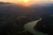 Aerial view of the valley, olive fields and Embalse de Forata reservoir during sunset. Summer in Spain