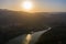 Aerial view of the valley, olive fields and Embalse de Forata reservoir during sunset. Summer in Spain