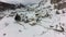 Aerial view of a valley with rural houses full of snow