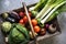 Aerial view of various fresh vegetable in wooden basket