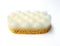 Aerial view of Vegetal massage sponge with friction surface for exfoliating action isolated on white background. Natural care.