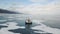 Aerial view of a vehicle with rubber air cushion on Siberian lake Baikal in winter. Clip. Rear view of a khivus boat