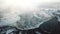 Aerial view of Venta waterfall, the widest waterfall in Europe and long brick bridge in foggy winter morning, Kuldiga, Latvia.