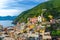 Aerial view of Vernazza village with typical colorful multicolored buildings houses, harbor, marina, green hills and Genoa Gulf, L