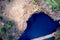 Aerial view, vertical down, of a blue lake in the heath