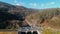 Aerial view of a very slowly upward movement passing a vehicle through the dam