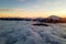 Aerial view of vibrant sunrise over white dense fog with distant dark Carpathian mountains on horizon