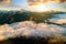 Aerial view of vibrant sunrise over white dense fog with distant dark Carpathian mountains on horizon