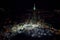 Aerial view of the vibrant urban cityscape of Saudi Arabia, featuring a towering spire.