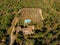 aerial view of villa with swimming pool near fields and forest