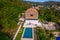 Aerial view of a villa with a swimming pool, private garden, terrace, in a quiet hill