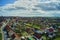 Aerial view of a village in Germany in bright sunshine with cloudy sky and many gardens and lawns