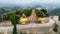 Aerial view of village historic stone buildings and Mausoleum Ruins in Polop, Spain