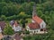 Aerial view of village Honau, Germany located in Echaz valley in Swabian Alb with historic church Galluskirche.