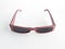 Aerial view of vintage sunglasses for women with retro pink frame color and dark lenses. Pair of luxury sunglasses isolated on