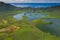 Aerial view of volcanic crater Caldeirao with a beautiful lake on the top of Corvo island. Azores islands, Portugal