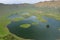 Aerial view of volcanic crater Caldeirao with a beautiful lake on the top of Corvo island. Azores islands, Portugal