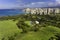 Aerial view of Waikiki skyline neighborhood and city park next to Queens Beach in Honolulu