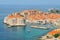 Aerial view of the walled city of Dubrovnik surrounded by the calm waters of the Adriatic Sea, Croatia