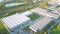 Aerial view of warehouse storages or industrial factory or logistics center from above. Top view of industrial buildings and