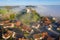 Aerial view of warm sunrise over a typical foggy Swiss medieval town Waltalingen. Hilltop Castle Schloss Schwandegg. Stammheim,