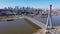 Aerial view of Warsaw current urban landscape on bank of Vistula and Swietokrzyski Bridge over river on sunny day