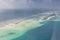 Aerial view of water bungalow and blue sea sky background in Maldives