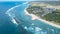 Aerial view of a waterfront area featuring several hotels and resorts in Bali, Indonesia.