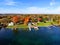 The aerial view of the waterfront residential area surrounded by striking fall foliage by St Lawrence River of Wellesley Island,