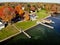 The aerial view of the waterfront residential area surrounded by striking fall foliage by St Lawrence River of Wellesley Island,